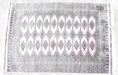 Lot 111 - A Persian wool Bokhara rug of pink ground,...