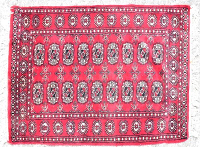 Lot 113 - A Bokhara wool runner of red ground, with...