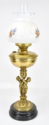 Lot 2241 - A 19th century brass figural column oil lamp,...