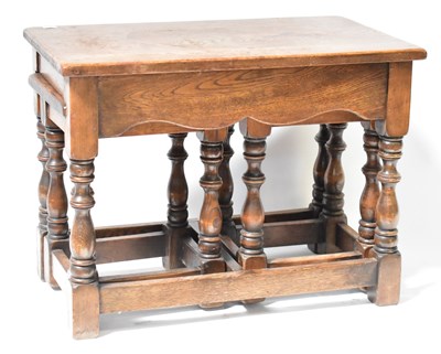 Lot 11 - A 20th century oak jointed nest of tables with...