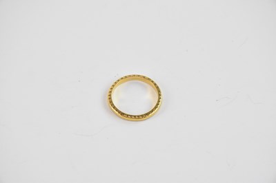Lot 854 - A 22ct yellow gold slim textured band, size P,...
