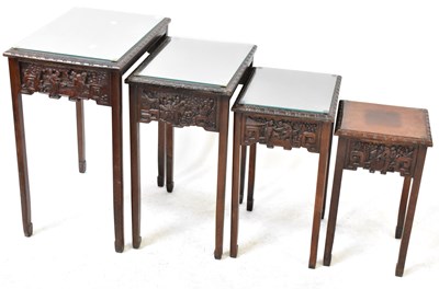 Lot 22 - A Chinese quartetto of glass topped tables,...