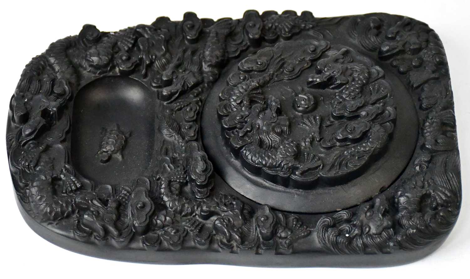 Lot 241 - A Chinese black ink stone, the mo-tang relief...