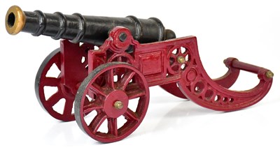 Lot 377 - A cast iron table cannon on wheels, 17 x 45cm.