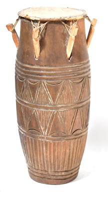 Lot 310 - A West African carved wooden tribal drum with...