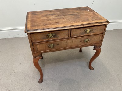 Lot 1295 - An 18th century style walnut lowboy, with two...