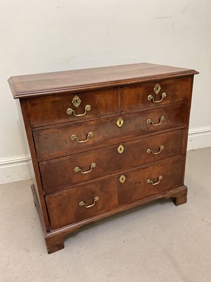 Lot 1252 - A Georgian walnut chest of two short over...