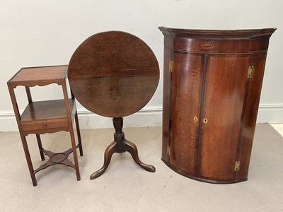 Lot 1253 - A Georgian inlaid oak bowfront hanging corner...