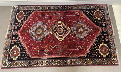 Lot 1407 - A red ground Eastern style rug.
