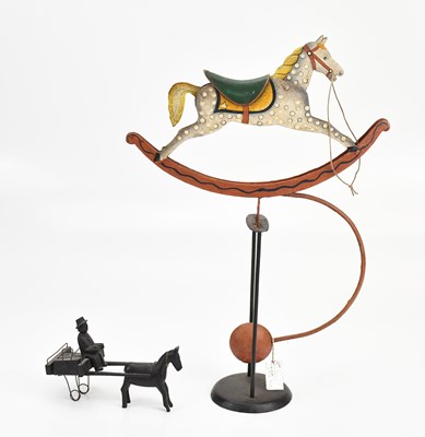 Lot 1822 - A painted metal balanced rocking horse, height...