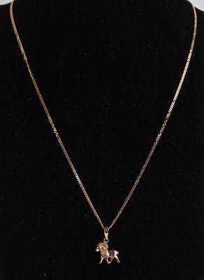 Lot 1364 - A 14ct rose gold pendant modelled as a ram,...
