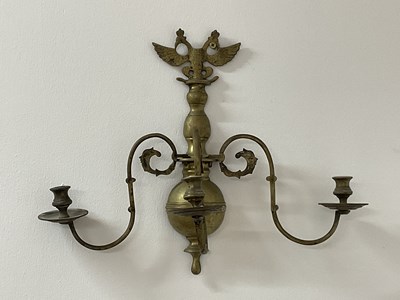 Lot 157 - A brass wall sconce with a double headed eagle,...