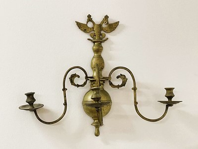 Lot 142 - A brass wall sconce with a double headed eagle,...