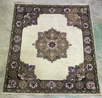Lot 751 - A hand woven Turkish style rug with a central...