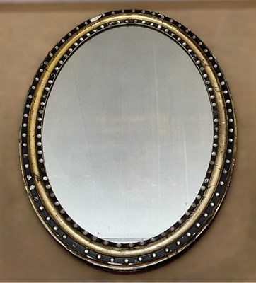 Lot 724 - A 20th century oval wall mirror, decorated to...