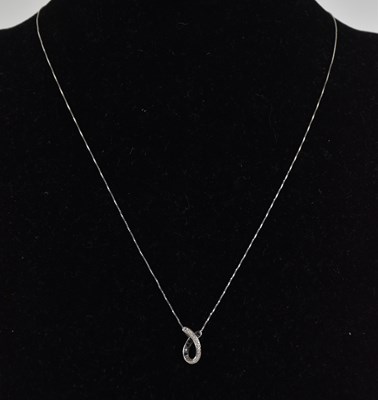 Lot 1382 - A 9ct white gold dainty necklace with ring...
