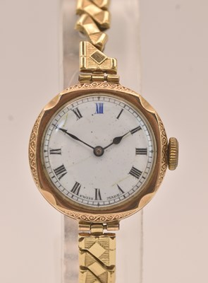 Lot 1556 - A lady's 9ct rose gold wristwatch, the white...