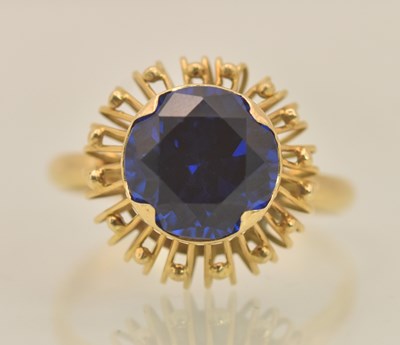 Lot 1298 - An 18ct yellow gold blue topaz set dress ring,...