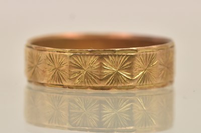 Lot 1302 - An 18ct yellow gold bright cut band ring, size...
