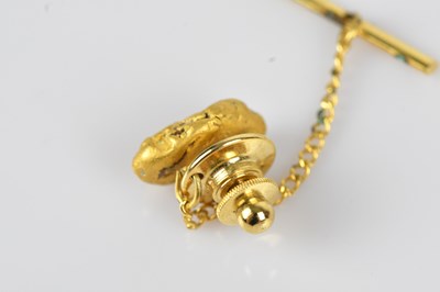 Lot 19 - A yellow metal nugget effect stickpin,...