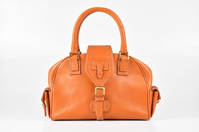 Lot 1383 - LOEWE; a burnt orange grained leather bowling...