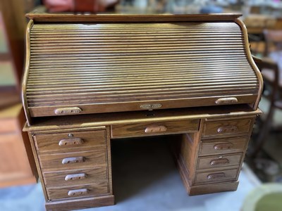 Lot 656 - An early 20th century oak tambour roll top...