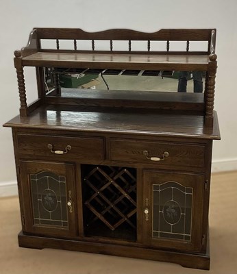 Lot 702 - An oak drinks cabinet with raised mirrored...