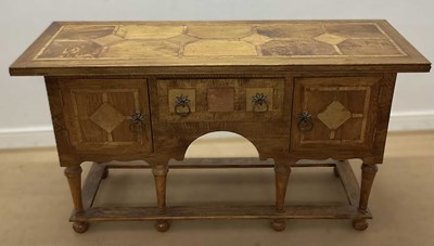 Lot 649 - A mangowood veneered sideboard with central...