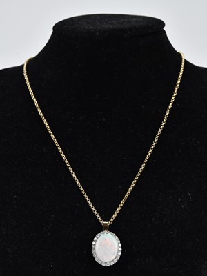 Lot 253 - A good diamond and opal pendant in yellow and...