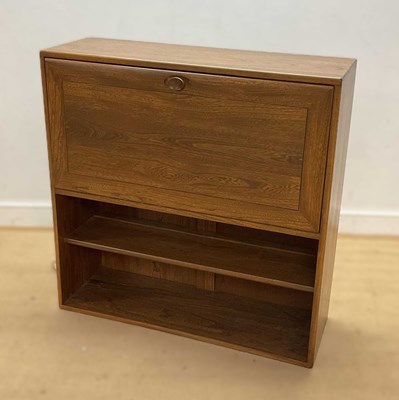 Lot 696 - ERCOL; a solid elm cabinet with dropdown bar,...