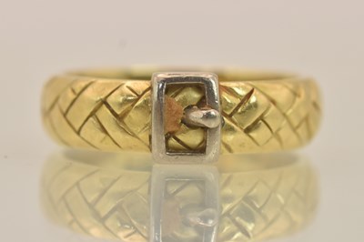 Lot 1279 - An 18ct yellow and white gold buckle ring,...