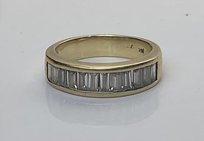 Lot 532 - A 14ct gold band ring inset with white stones,...