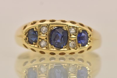 Lot 1303 - An 18ct yellow gold sapphire and diamond three...