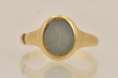 Lot 1311 - An 18ct yellow gold oval face hardstone set...