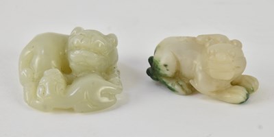 Lot 1031 - A small Chinese carved green jade figure of a...