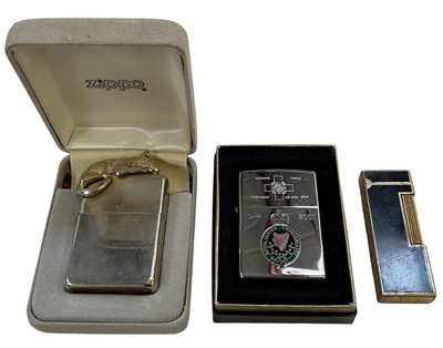 Lot 310 - ZIPPO; a boxed stainless steel and brass...
