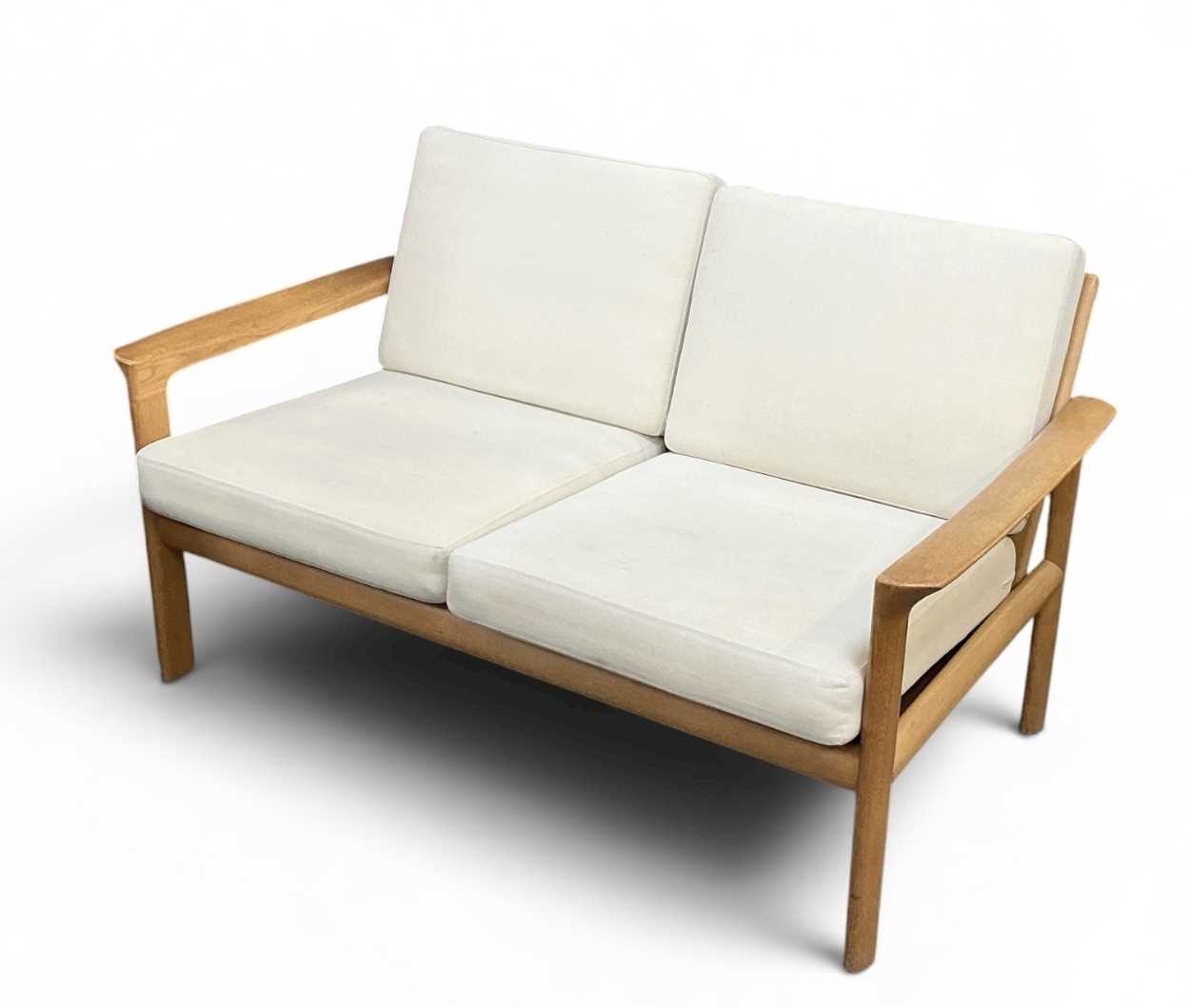 Lot 18 - A modern Danish light oak framed two seater...