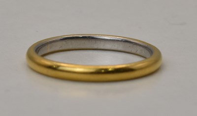Lot 531 - A 22ct gold and platinum two-tone wedding band,...