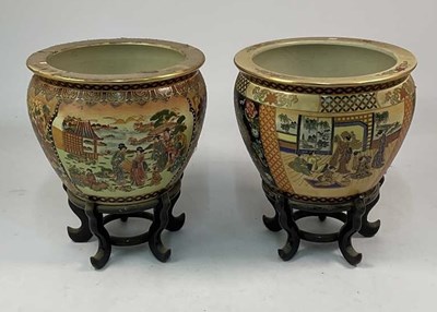 Lot 130 - A pair of Japanese ceramic planters raised on...