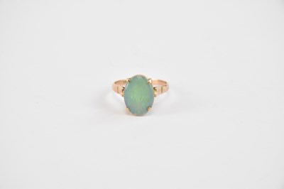 Lot 869 - A 14ct yellow gold ring set with an oval opal,...