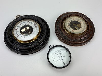Lot 2213 - A late Victorian carved oak aneroid barometer,...