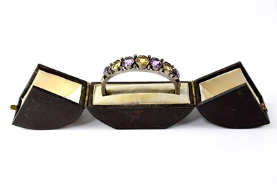 Lot 990 - A white metal bangle set with graduated...