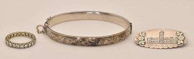 Lot 1452 - A silver hinged bracelet with floral...