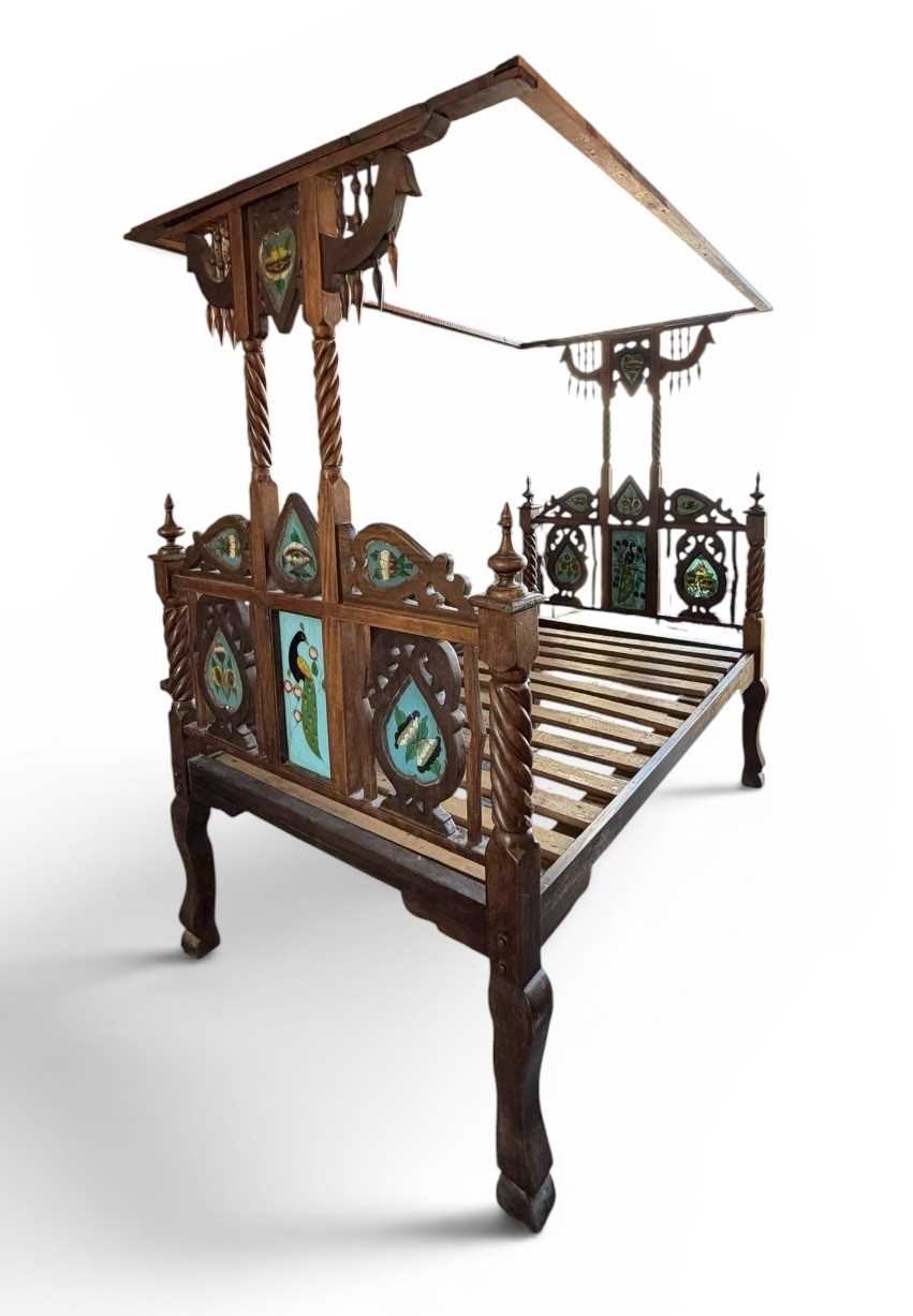 Lot 12 - An Indian carved hardwood 'Lamu' bed, the...