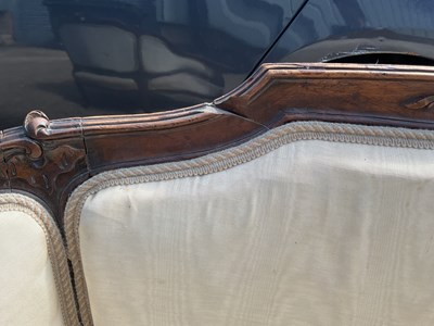 Lot 31 - A late 19th century carved walnut framed...