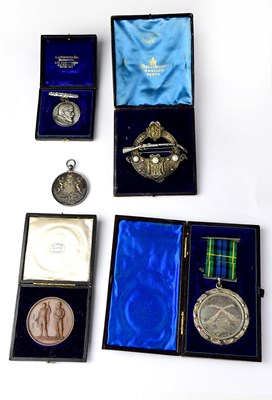 Lot 1060 - A white metal Scottish brooch with rifle set...