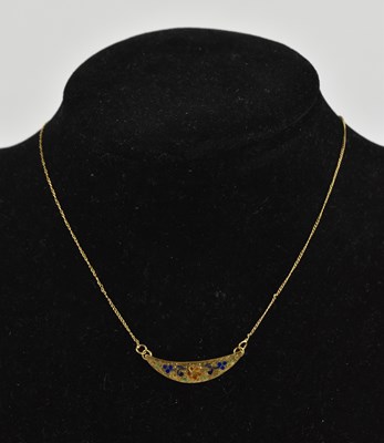 Lot 330 - A yellow metal and enamel crescent shaped...