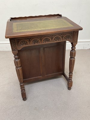 Lot 1136 - An early 20th century oak Davenport type...