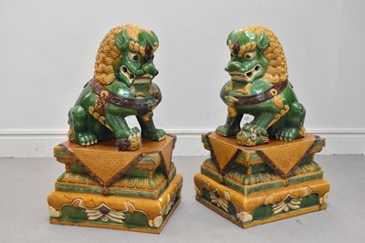 Lot 1419 - A pair of Dogs of Fo garden ornaments with...