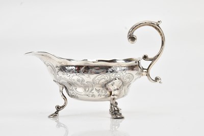 Lot 394 - A George III hallmarked silver cream jug, with...